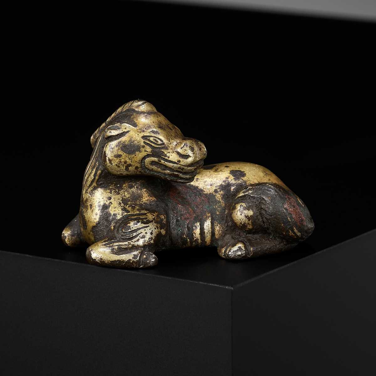 Lot 621 - A GILT-BRONZE ‘XINIU’ WEIGHT, MING DYNASTY