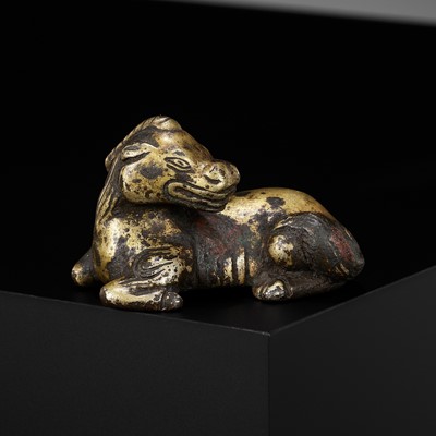 Lot 621 - A GILT-BRONZE ‘XINIU’ WEIGHT, MING DYNASTY