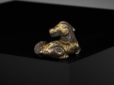 Lot 621 - A GILT-BRONZE ‘XINIU’ WEIGHT, MING DYNASTY