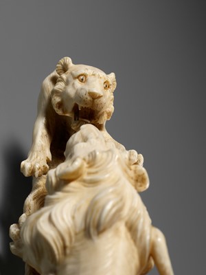 Lot 293 - KOZAN: AN IVORY OKIMONO OF THREE FIGHTING LIONS