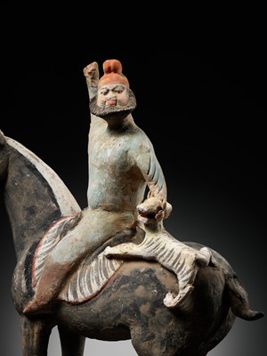 Lot 61 - A RARE PAINTED POTTERY HORSE WITH A ‘PHRYGIAN’ RIDER AND TIGER CUB, TANG DYNASTY