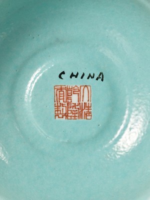 Lot 540 - A PAIR OF LARGE RUBY-GROUND FAMILLE ROSE BUDDHIST EMBLEM ALTAR ORNAMENTS, QING DYNASTY