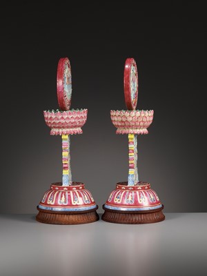 Lot 540 - A PAIR OF LARGE RUBY-GROUND FAMILLE ROSE BUDDHIST EMBLEM ALTAR ORNAMENTS, QING DYNASTY