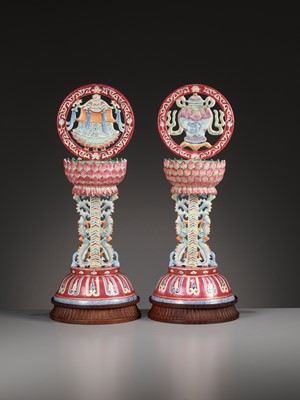 Lot 540 - A PAIR OF LARGE RUBY-GROUND FAMILLE ROSE BUDDHIST EMBLEM ALTAR ORNAMENTS, QING DYNASTY