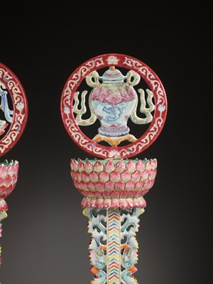 Lot 540 - A PAIR OF LARGE RUBY-GROUND FAMILLE ROSE BUDDHIST EMBLEM ALTAR ORNAMENTS, QING DYNASTY