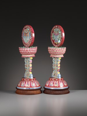 Lot 540 - A PAIR OF LARGE RUBY-GROUND FAMILLE ROSE BUDDHIST EMBLEM ALTAR ORNAMENTS, QING DYNASTY