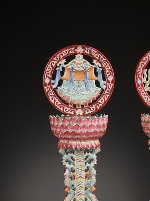 Lot 540 - A PAIR OF LARGE RUBY-GROUND FAMILLE ROSE BUDDHIST EMBLEM ALTAR ORNAMENTS, QING DYNASTY