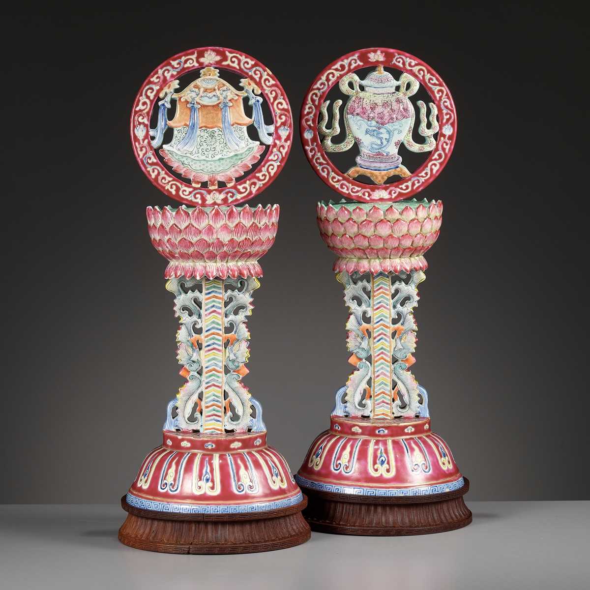 Lot 540 - A PAIR OF LARGE RUBY-GROUND FAMILLE ROSE BUDDHIST EMBLEM ALTAR ORNAMENTS, QING DYNASTY
