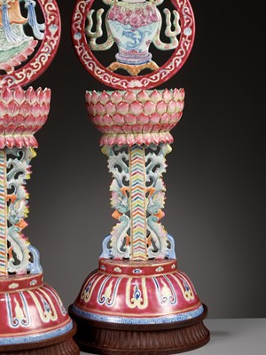 Lot 540 - A PAIR OF LARGE RUBY-GROUND FAMILLE ROSE BUDDHIST EMBLEM ALTAR ORNAMENTS, QING DYNASTY