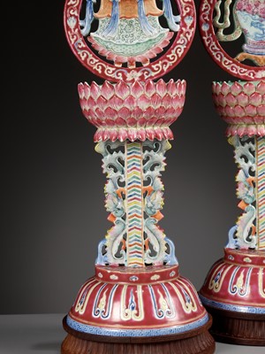 Lot 540 - A PAIR OF LARGE RUBY-GROUND FAMILLE ROSE BUDDHIST EMBLEM ALTAR ORNAMENTS, QING DYNASTY