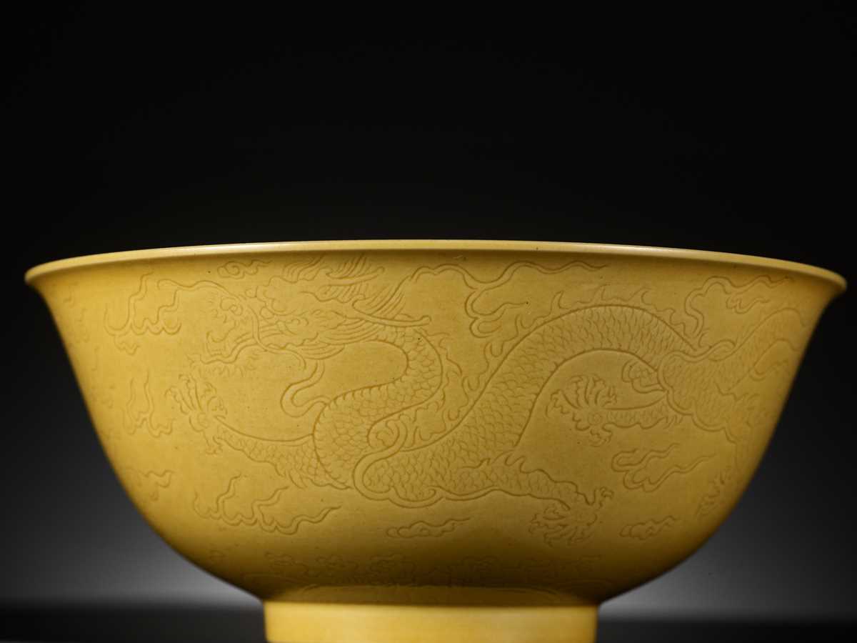 Lot 113 - AN IMPERIAL YELLOW-GLAZED AND INCISED ‘DRAGON’ BOWL, QIANLONG MARK AND PERIOD