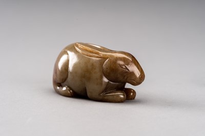 Lot 112 - A CELADON AND RUSSET JADE FIGURE OF A RABBIT, QING