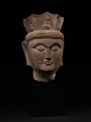 Lot 168 - A MONUMENTAL HEAD OF VAIROCANA, THE PRIMORDIAL BUDDHA, CIRCA 500-800 AD