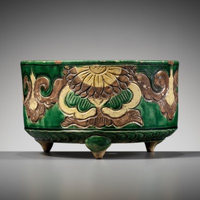 Lot 157 - A GREEN, AUBERGINE, AND YELLOW-GLAZED TRIPOD CENSER, LIAO DYNASTY