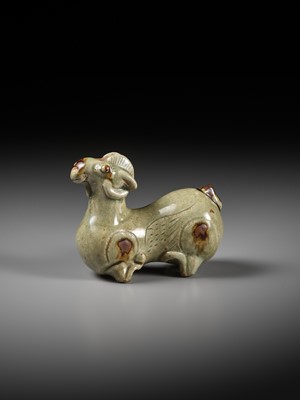 Lot 64 - A RARE IRON-SPLASHED ‘YUE’ FIGURE OF A RECUMBENT RAM, WESTERN JIN DYNASTY