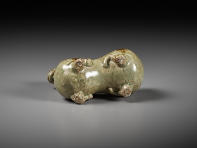 Lot 64 - A RARE IRON-SPLASHED ‘YUE’ FIGURE OF A RECUMBENT RAM, WESTERN JIN DYNASTY