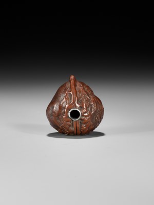 Lot 320 - A VERY FINE KURUMI (WALNUT) NETSUKE WITH SHISHI AND PEONY