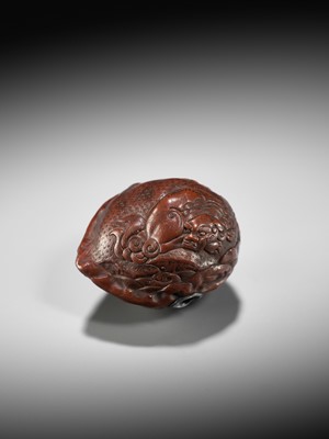 Lot 320 - A VERY FINE KURUMI (WALNUT) NETSUKE WITH SHISHI AND PEONY