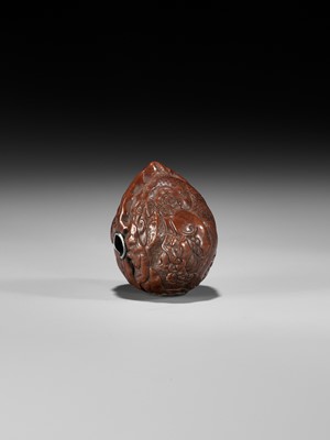 Lot 320 - A VERY FINE KURUMI (WALNUT) NETSUKE WITH SHISHI AND PEONY