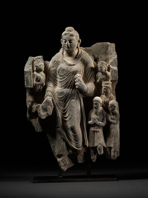 Lot 231 - A LARGE GRAY SCHIST RELIEF DEPICTING BUDDHA, A ROYAL DONOR AND SEVERAL ATTENDANTS, ANCIENT REGION OF GANDHARA, 2ND-3RD CENTURY