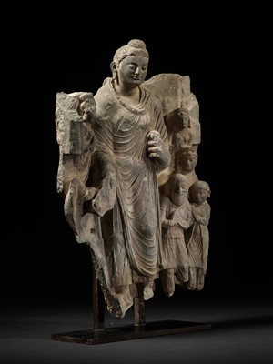 Lot 231 - A LARGE GRAY SCHIST RELIEF DEPICTING BUDDHA, A ROYAL DONOR AND SEVERAL ATTENDANTS, ANCIENT REGION OF GANDHARA, 2ND-3RD CENTURY