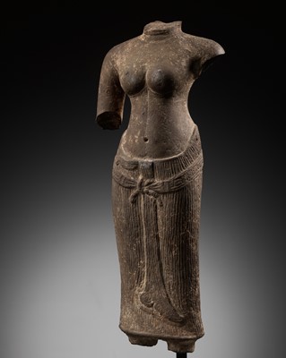 Lot 273 - A SANDSTONE TORSO OF UMA, ANGKOR PERIOD, BAPHUON STYLE