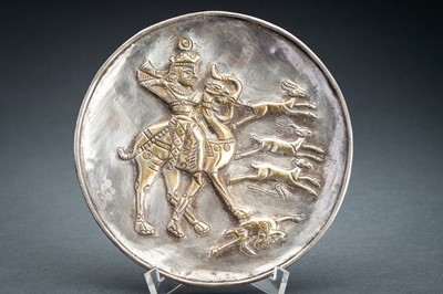 Lot 783 - A PERSIAN PARCEL-GILT SILVER REPOUSSÉ ‘HUNTER’ DISH