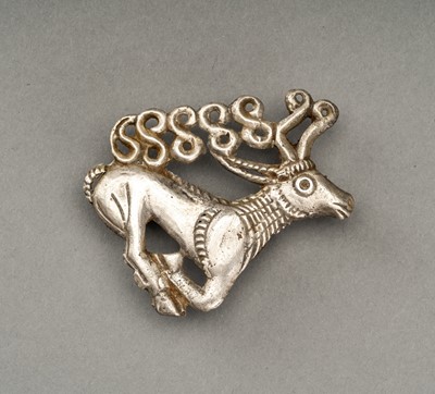 Lot 748 - AN ANCIENT SILVER PLAQUE IN THE SHAPE OF A STAG