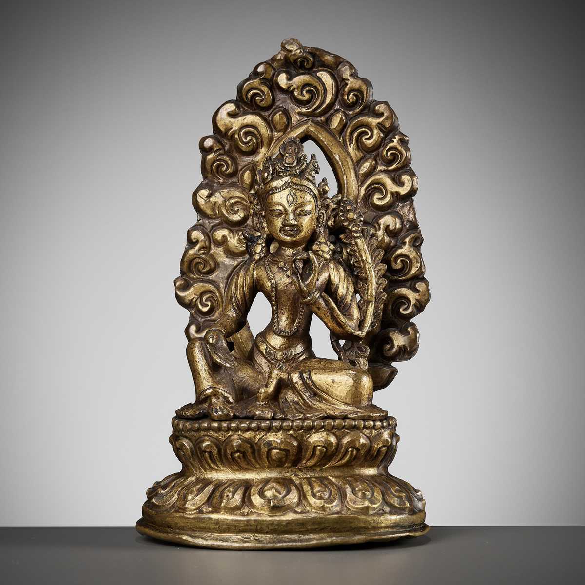 Lot 673 - A GILT COPPER REPOUSSÉ FIGURE OF TARA, NEPAL, 18TH-19TH CENTURY