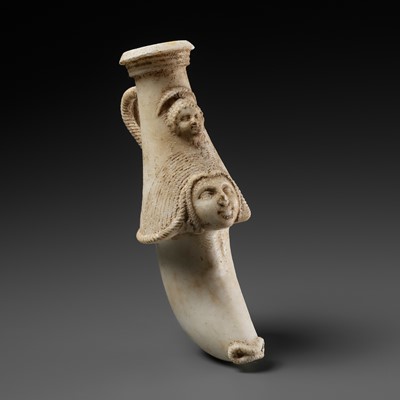 Lot 1665 - A WESTERN ASIATIC ALABASTER RHYTON WITH MOTHER GODDESS AND CHILD