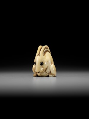 Lot 146 - YOSHINAGA: AN IVORY NETSUKE OF A CROUCHING RABBIT