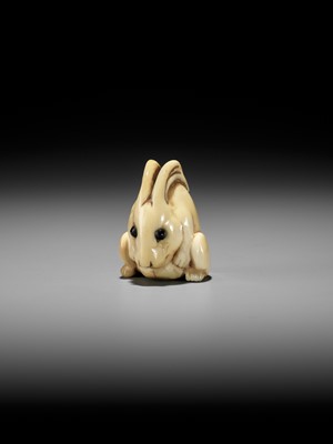 Lot 146 - YOSHINAGA: AN IVORY NETSUKE OF A CROUCHING RABBIT