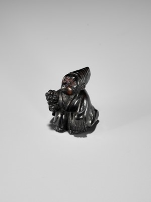 Lot 450 - A CHARMING KUROGAKI (BLACK PERSIMMON) WOOD NETSUKE OF A MONKEY AS A SAMBASO DANCER