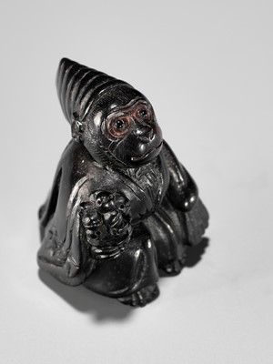 Lot 450 - A CHARMING KUROGAKI (BLACK PERSIMMON) WOOD NETSUKE OF A MONKEY AS A SAMBASO DANCER