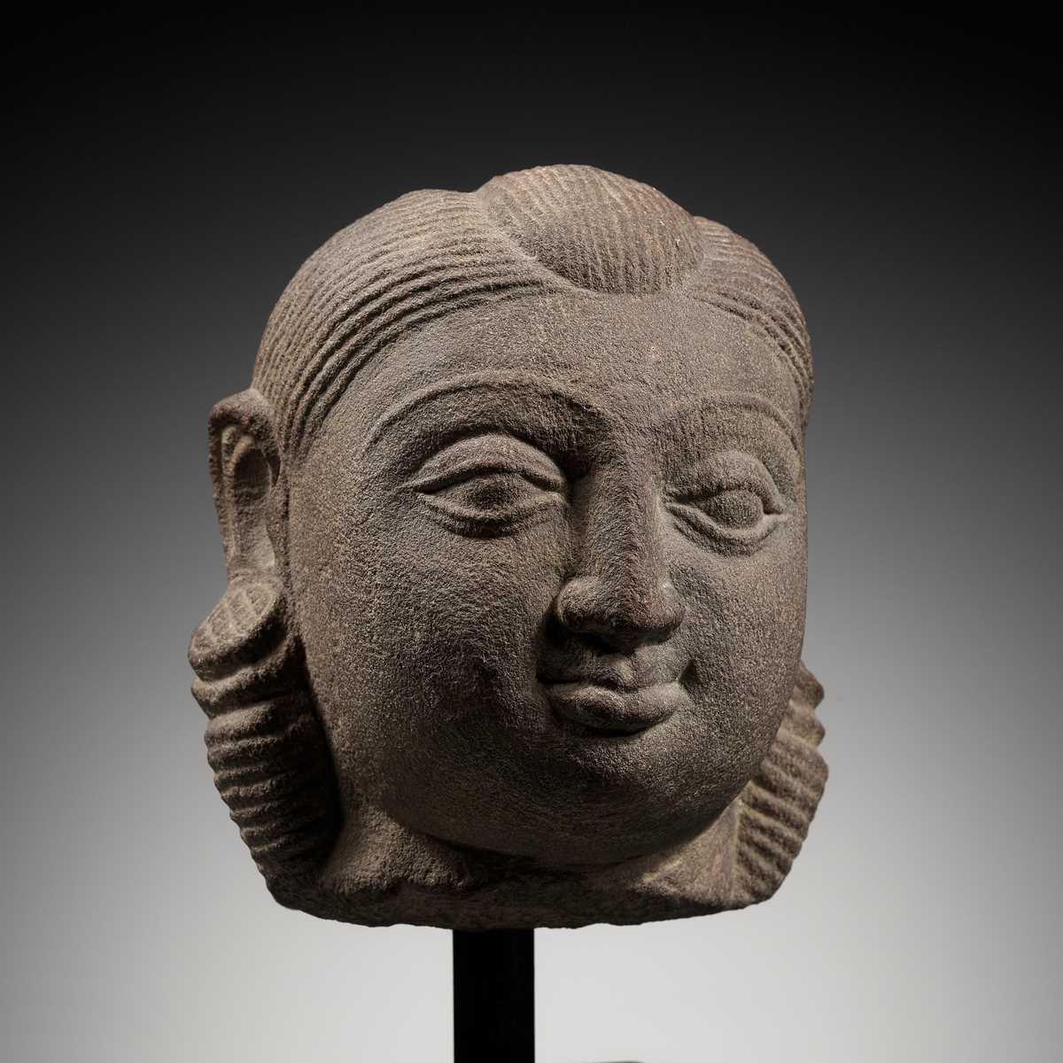 Lot 718 - A PINK SANDSTONE HEAD OF A YAKSHI, MATHURA, KUSHAN PERIOD