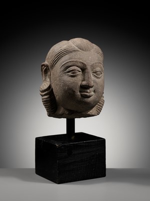 Lot 718 - A PINK SANDSTONE HEAD OF A YAKSHI, MATHURA, KUSHAN PERIOD