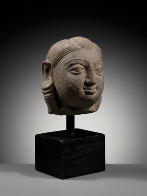 Lot 718 - A PINK SANDSTONE HEAD OF A YAKSHI, MATHURA, KUSHAN PERIOD