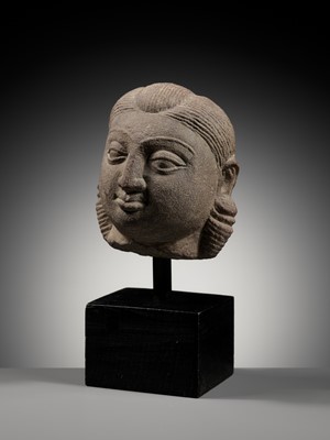 Lot 718 - A PINK SANDSTONE HEAD OF A YAKSHI, MATHURA, KUSHAN PERIOD