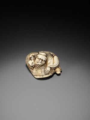 Lot 165 - AN AMUSING OSAKA SCHOOL IVORY NETSUKE OF SHOKI CAPTURING AN ONI, ATTRIBUTED TO HIDEMASA