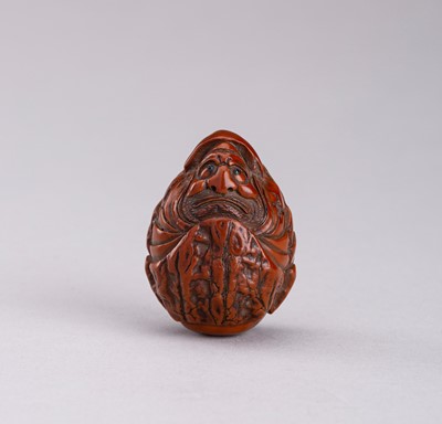 Lot 800 - A SIGNED WALNUT NETSUKE OF DARUMA, MEIJI