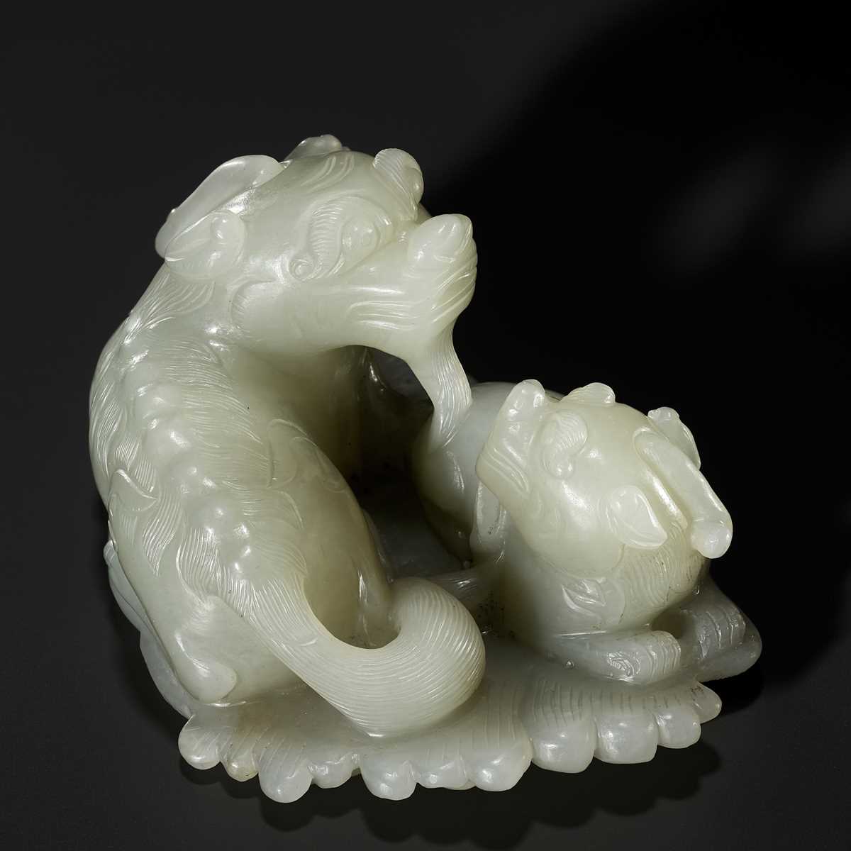 Lot 343 - A PALE CELADON JADE ‘QILIN AND YOUNG’ GROUP, MID-QING DYNASTY