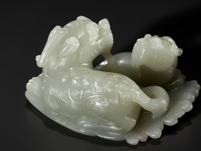 Lot 343 - A PALE CELADON JADE ‘QILIN AND YOUNG’ GROUP, MID-QING DYNASTY