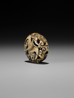 Lot 477 - A RARE ANTLER RYUSA MANJU NETSUKE OF A STYLIZED ‘BAT’ DRAGON