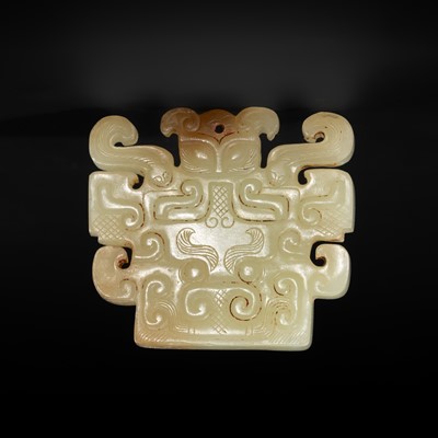 A RARE PALE CELADON JADE ‘MASK’ PENDANT, EASTERN ZHOU DYNASTY