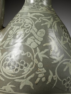 Lot 167 - A SLIP-INLAID ‘CHILDREN AND GRAPEVINES’ CELADON EWER, GORYEO DYNASTY (918-1392)