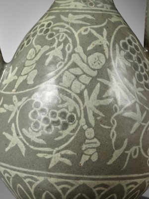 Lot 167 - A SLIP-INLAID ‘CHILDREN AND GRAPEVINES’ CELADON EWER, GORYEO DYNASTY (918-1392)