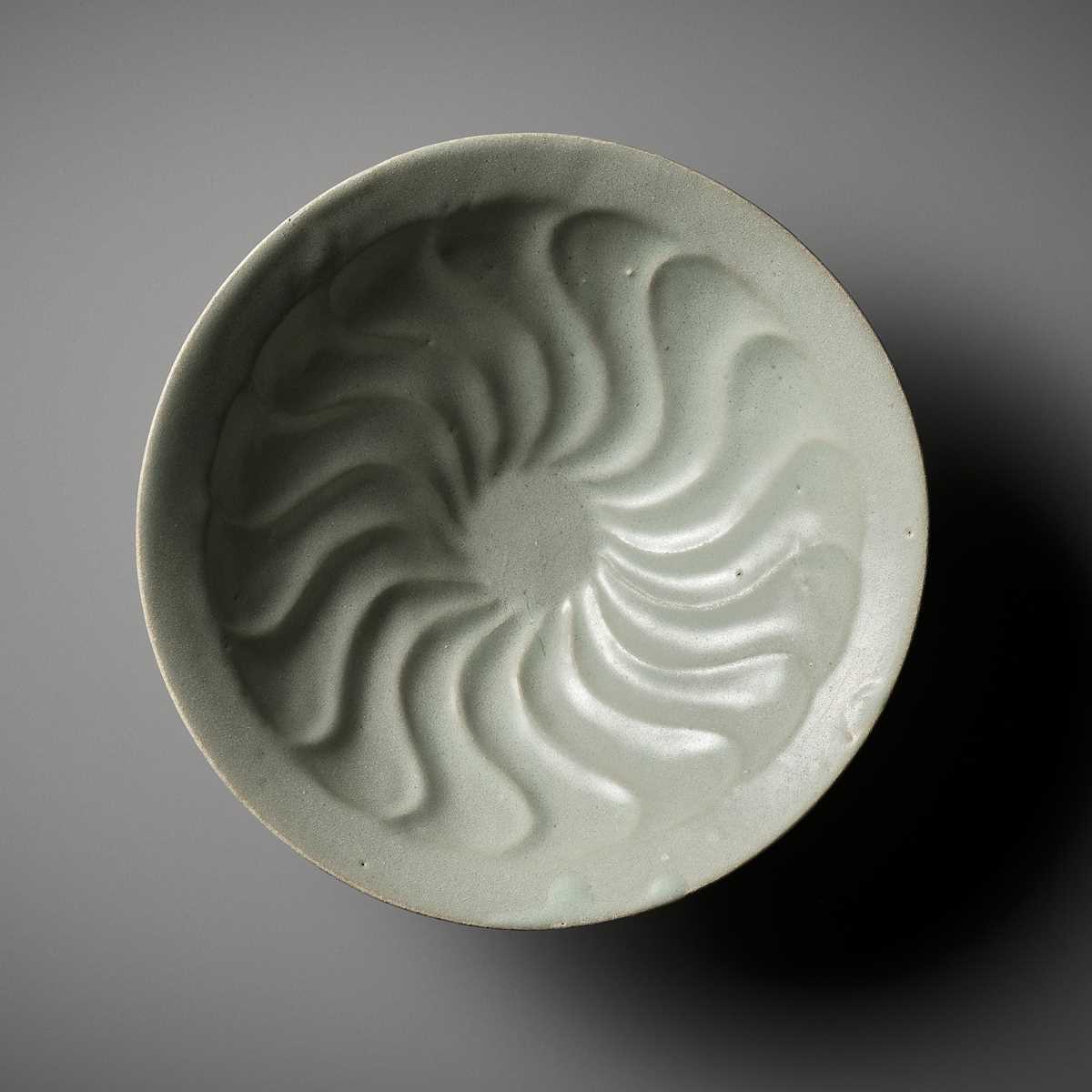 Lot 168 - A MOLDED AND CELADON-GLAZED ‘FLORAL’ BOWL, GORYEO DYNASTY, KOREA, 14TH CENTURY