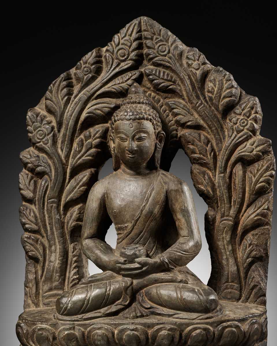 Lot 668 - A LIMESTONE FIGURE OF BUDDHA AMITABHA UNDER THE BODHI TREE, NEPAL, 17TH-18TH CENTURY
