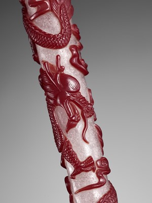 Lot 22 - A CARVED RED OVERLAY SNOWFLAKE GLASS ‘DRAGON’ BRUSH HANDLE, QING DYNASTY
