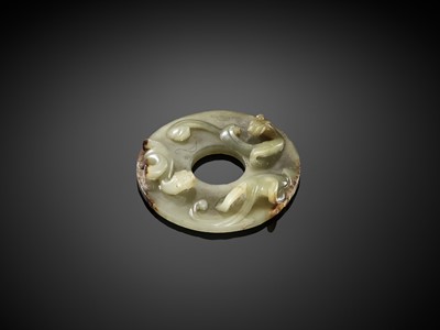 A CELADON JADE DISC WITH COILED DRAGONS, WESTERN HAN DYNASTY